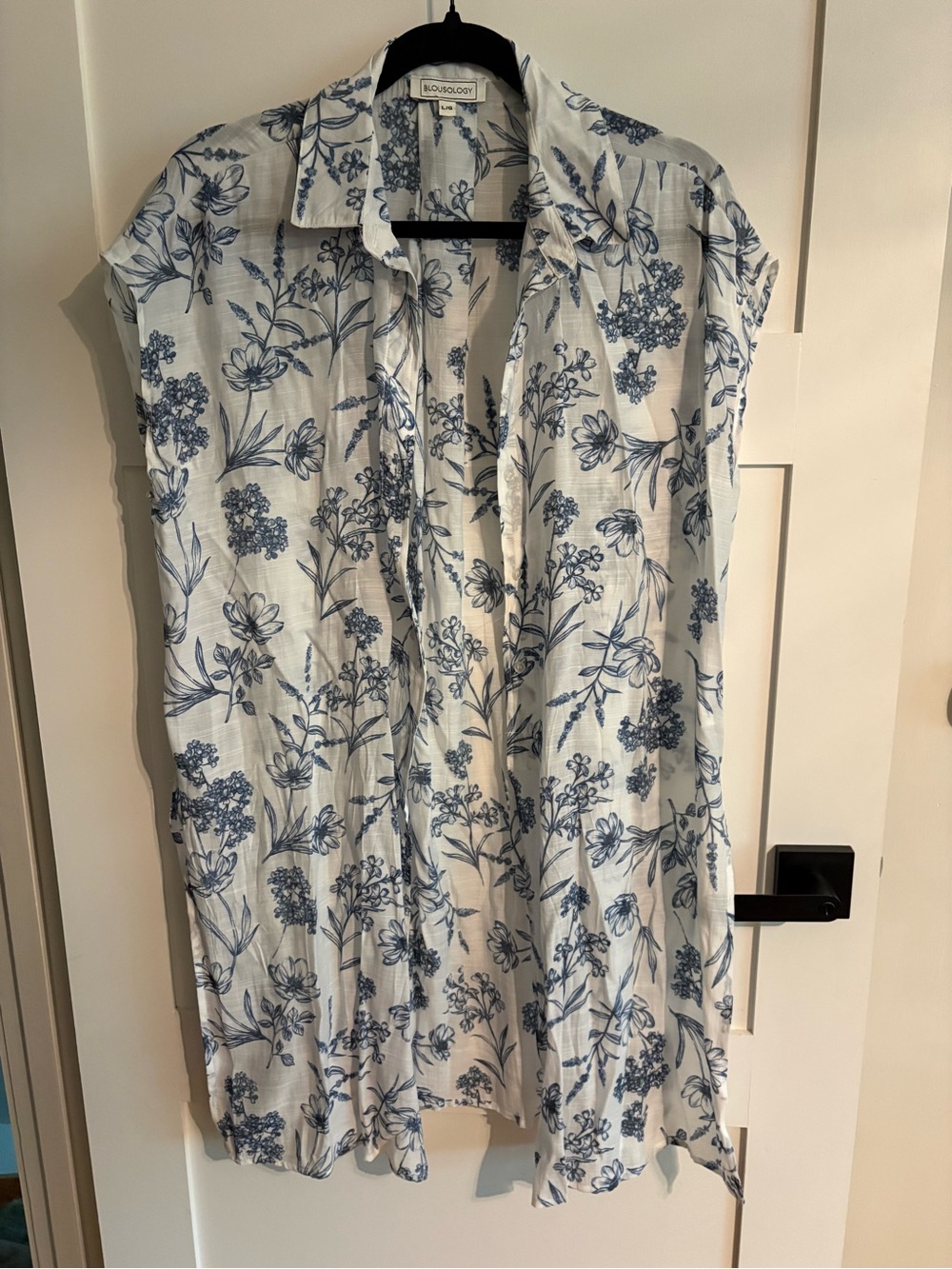 Sleeveless White Blouse with Blue Floral Print